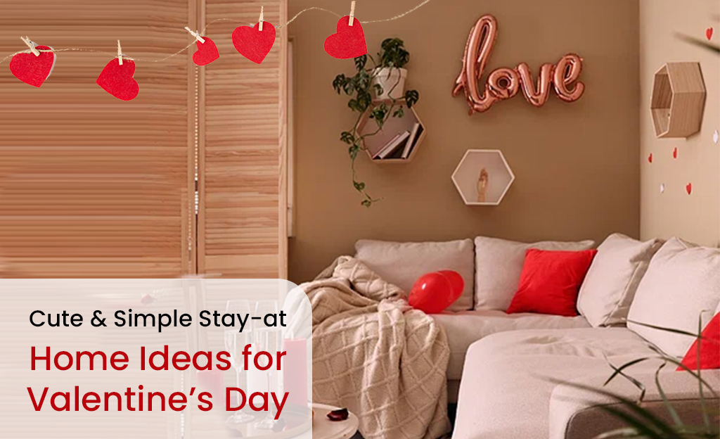A cozy living room decorated for Valentine's Day. There is a sofa with red pillows, a string of heart-shaped decorations, a "Love" balloon, and other Valentine's Day decor. The text "Cute & Simple Stay-at-Home Ideas for Valentine's Day" is also included.