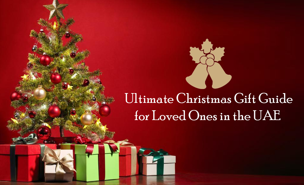 A beautifully decorated Christmas tree with colorful ornaments, surrounded by wrapped gifts. The text "Ultimate Christmas Gift Guide for Loved Ones in the UAE" is displayed above the image.