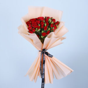 A bouquet of red roses tied with a black ribbon