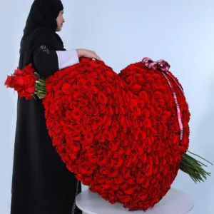 The image shows a large heart-shaped arrangement of red roses. It appears to be a very large and elaborate bouquet, possibly made for a special occasion like Valentine's Day.