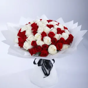 The bouquet is composed of numerous roses, alternating between a deep, vibrant red and a pure, bright white.