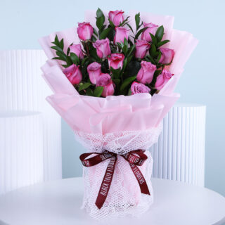 Hand-tied bouquet of roses and greenery, elegantly arranged for Women's Day.