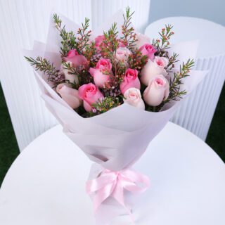 A beautiful bouquet of pink roses and luxury pink wax fillers elegantly wrapped in pristine white and finished with a delicate pink ribbon.