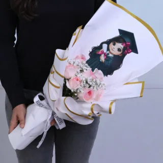 Pink rose graduation bouquet composed of fresh flowers arranged in an elegant aesthetic style, wrapped in premium floral paper and ribbon