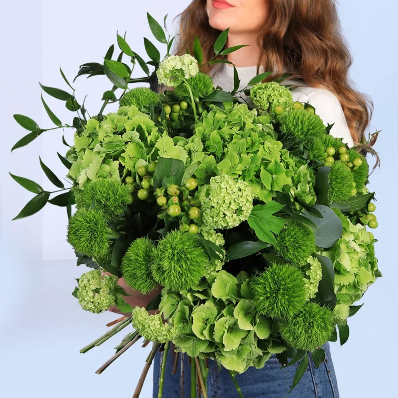 luxury-green-floral-bouquet Fresh green bouquet arrangement combining soft hydrangea, viburnum clusters, hypericum berries, and lush leafy foliage in a modern wrap