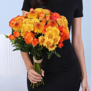 Orange flower bunch arranged in a vibrant and warm style, wrapped neatly for a cheerful presentation.