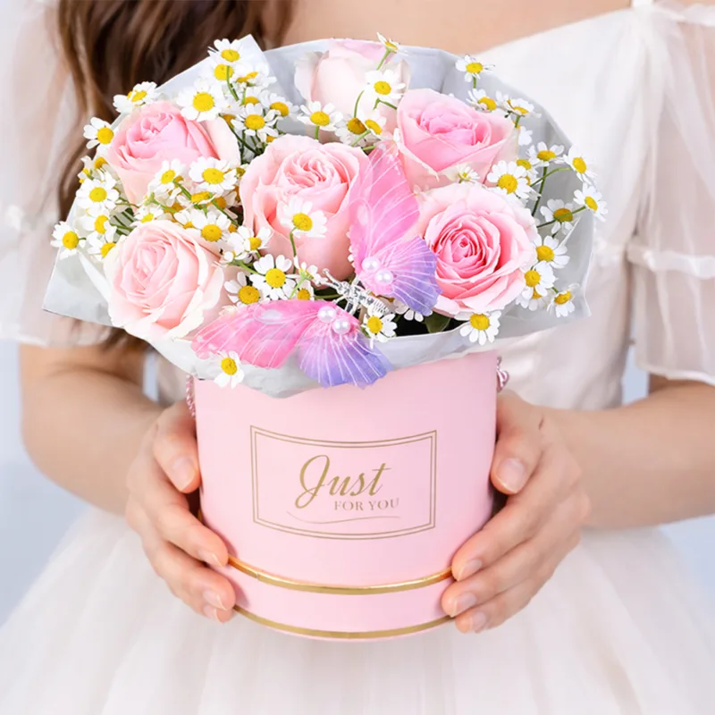 sweet-pink-cheer-box Elegant arrangement of blush pink roses with delicate white tanacetum blooms in a premium floral box.