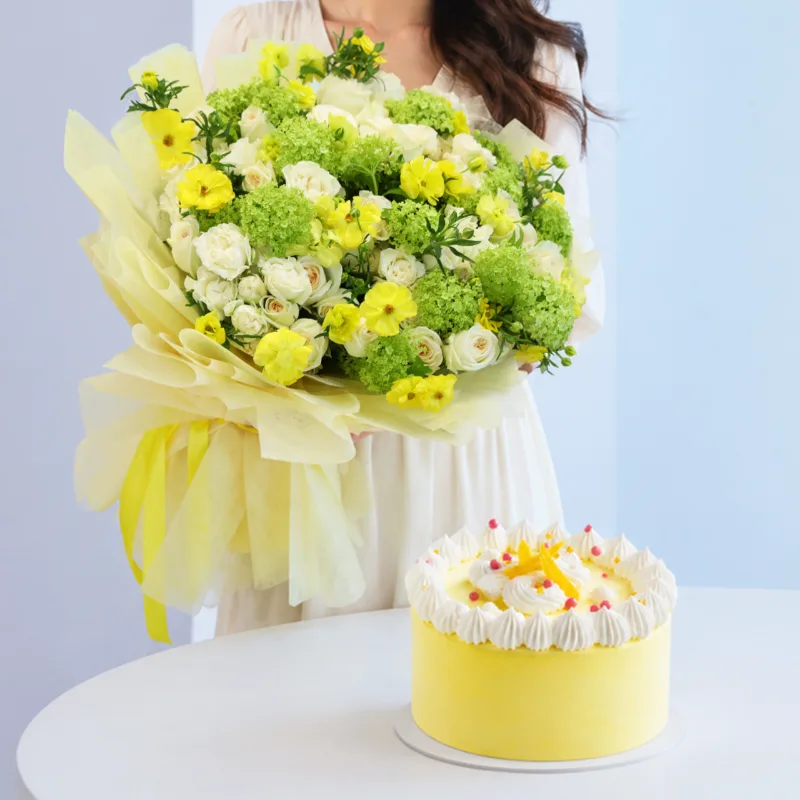 golden-bloom-mango-cake-combo Stylish flower bouquet with cream and yellow blooms paired with a refreshing mango ice cream cake bundle