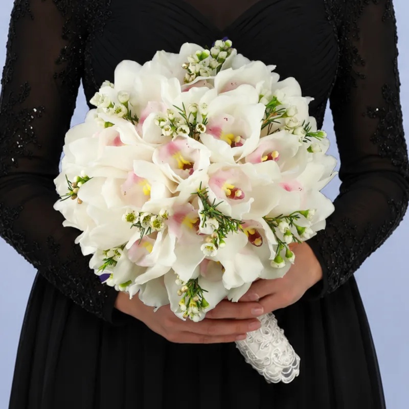 pearl-white-bridal-bouquet Luxury bridal bouquet featuring white orchids and delicate wax blooms designed for modern bridal styling