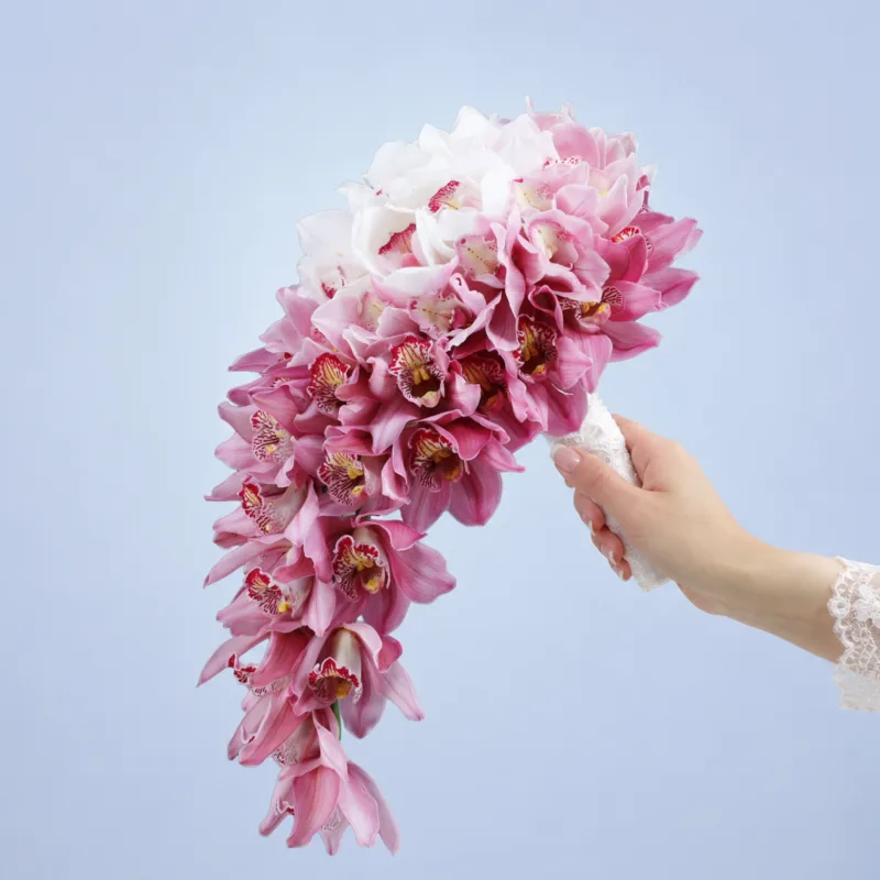 sweet-romance-cascade Luxury pink and ivory bridal bouquet arranged in a waterfall style, creating a graceful and sophisticated wedding look.