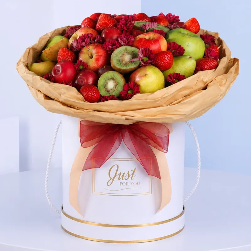 fruit-and-flower-arrangement Decorative arrangement of assorted fruits and fresh flowers in an elegant white round box presentation.