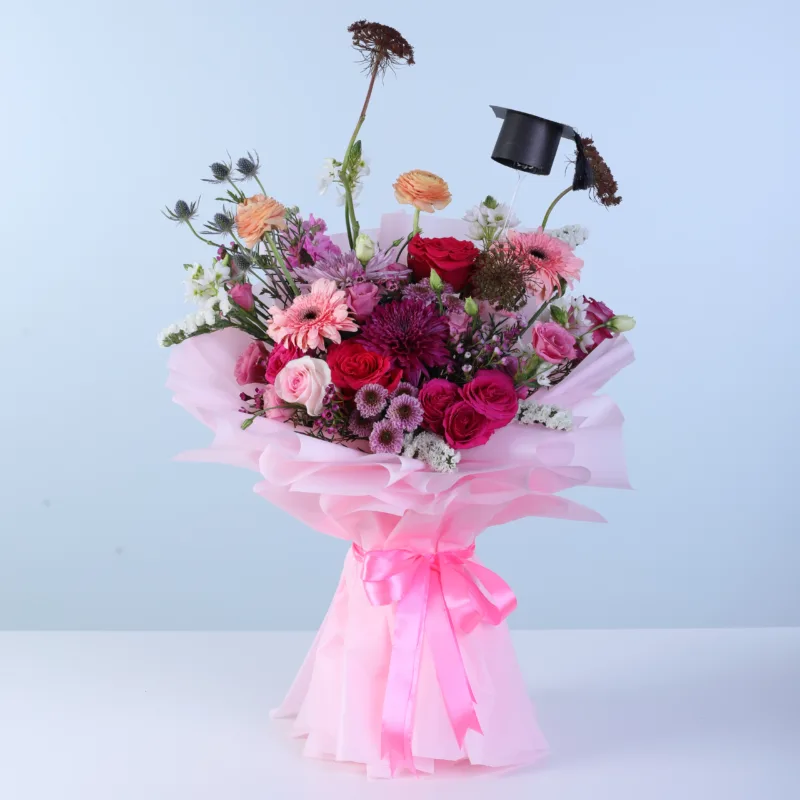 graduation-mixed-flower-bouquet Mixed floral graduation bouquet featuring fresh seasonal blooms like roses, ranunculus, gerberas, and chrysanthemums designed for graduation celebrations.