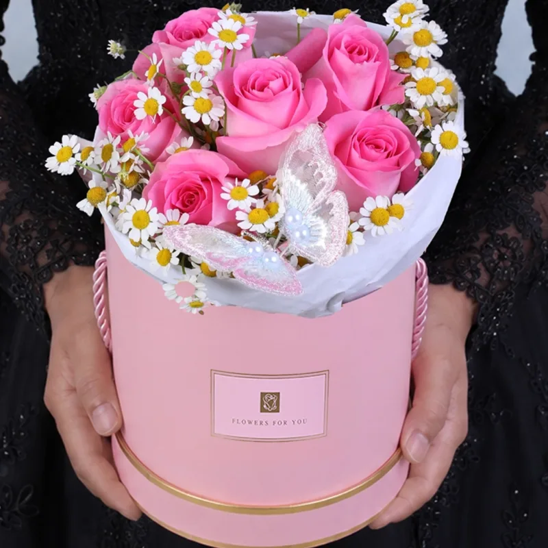 pink-butterfly-luxe-box_2026_01 A pink rose floral box with delicate flowers and a butterfly gently placed among the blooms, creating a soft, romantic, and beautiful gift arrangement.