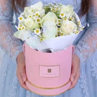 A white rose floral box with delicate white flowers and a butterfly gently placed among the blooms, creating a soft, pure, and elegant arrangement.
