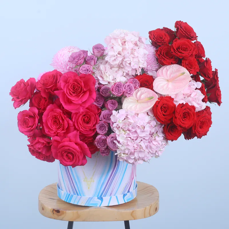 exquisite-floral-hat-box Exquisite Floral Hat Box featuring red roses, dark pink roses, light pink hydrangeas, purple spray roses, anthuriums, and light pink Deco chrysanthemum beautifully arranged in a premium hat box.