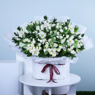 Grand White Flower Box featuring 100 white roses, 100 white tulips, and fresh ruscus beautifully arranged in a luxurious square flower box.