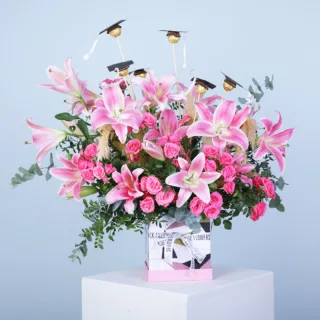 Pink Graduation Flower Box with Ferrero Rocher featuring fresh pink flowers, lush greenery, and 6 Ferrero Rocher chocolates beautifully arranged in a premium flower box.