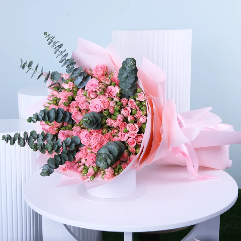 pink-rose-bouquet-with-eucalyptus Pink Rose Bouquet with Eucalyptus featuring fresh pink roses, pink spray roses, and eucalyptus beautifully arranged in an elegant hand bouquet.