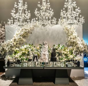 The chandeliers are ornate, with multiple tiers of crystals, casting a soft light on the scene.